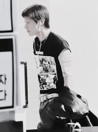 a black and white photo of a man wearing a t - shirt