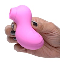 a hand holding a pink vibrating toy