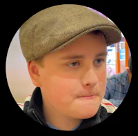 a young boy wearing a hat and staring at the camera