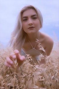 a young woman in a field of wheat