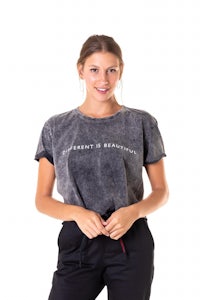 a woman wearing a grey t - shirt and black pants