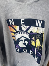 a grey hoodie with an image of new york on it