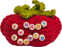 a crocheted tomato with the words i made a tomato