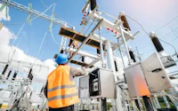 a worker is standing in front of an electrical substation