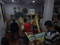 a group of people in an art studio with easels