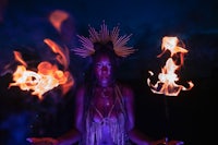 a woman holding a fire stick in her hands