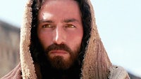 jesus with a beard and a hooded cloak