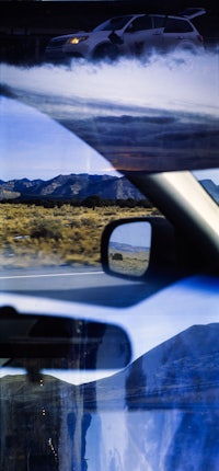 a car with smoke coming out of it's rear view mirror