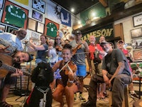 a group of people posing for a picture in a bar