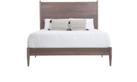 a bed with a wooden headboard and white pillows