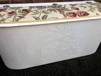 a white trunk with a floral pattern on it