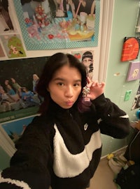 a girl wearing a black and white nike fleece jacket