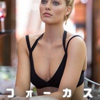 a woman in a black bikini sitting at a table