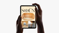 a person holding up a smartphone with the word sourn on it