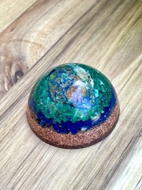 a blue and green sphere on top of a wooden table