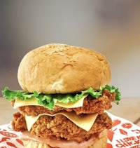 a chicken sandwich is sitting on top of a piece of paper
