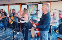 a group of people playing music in a room