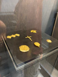 a display of gold coins in a glass case