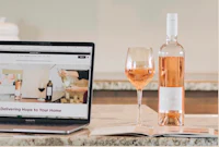 a laptop with a bottle of wine and a bottle of wine on it