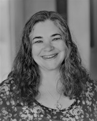a black and white photo of a woman smiling