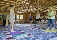 a group of people practicing yoga in a room