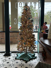 a christmas tree in front of a store