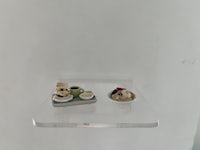 a small display of desserts on a clear glass shelf