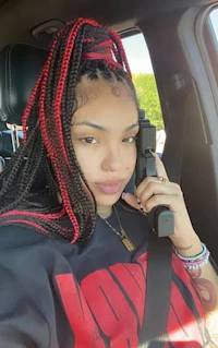 a woman in a car holding a cell phone