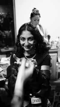 a black and white photo of a woman holding a cell phone