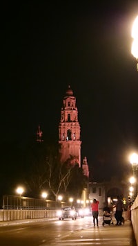 a city at night with a clock tower in the background