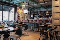 the interior of a restaurant with tables and chairs