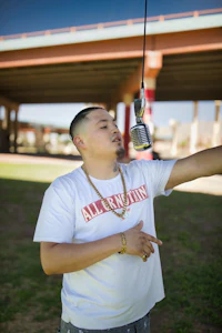 a man in a white shirt holding a microphone