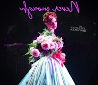 a woman in a dress holding a bouquet of flowers