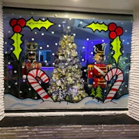 a christmas window display with nutcrackers and candy canes