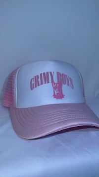 a pink trucker hat with the word grimy boys on it