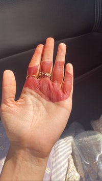 a person's hand with a ring on it