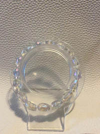 a clear crystal holder on a white surface