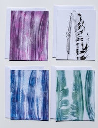 a set of greeting cards with feathers on them