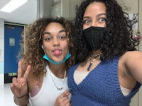 two girls taking a selfie in a locker room