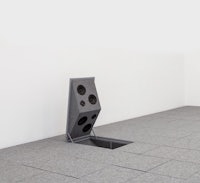 a speaker is sitting on the floor of an empty room