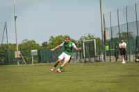 a man is kicking a soccer ball