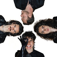 a group of people posing in front of a white background