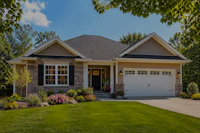 a home with a garage and grass in the front yard