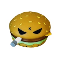 a toy burger with a cigarette in its mouth