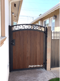 a wooden gate in front of a house