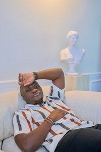 a man laying on a white couch