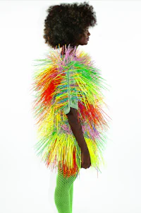 a black woman wearing a colorful fur coat