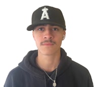 a young man with a mustache and a black hat