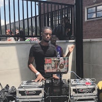 a dj is standing in front of a set of dj equipment