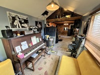 a living room with a piano and a couch